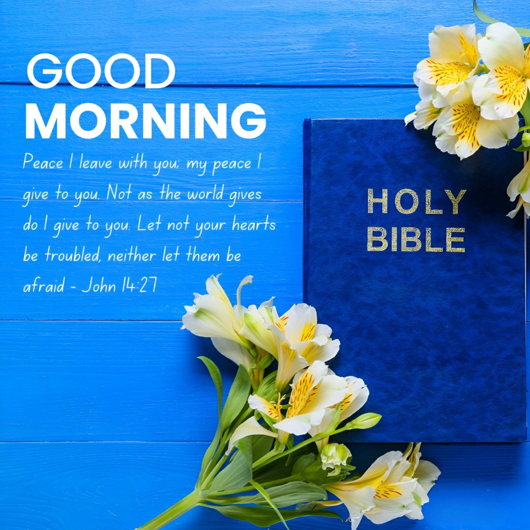 Good Morning message from John 14:27 on a blue wooden background, next to a blue Holy Bible and white yellow flowers, symbolizing Good Morning Bible Verses for Guidance and Wisdom.