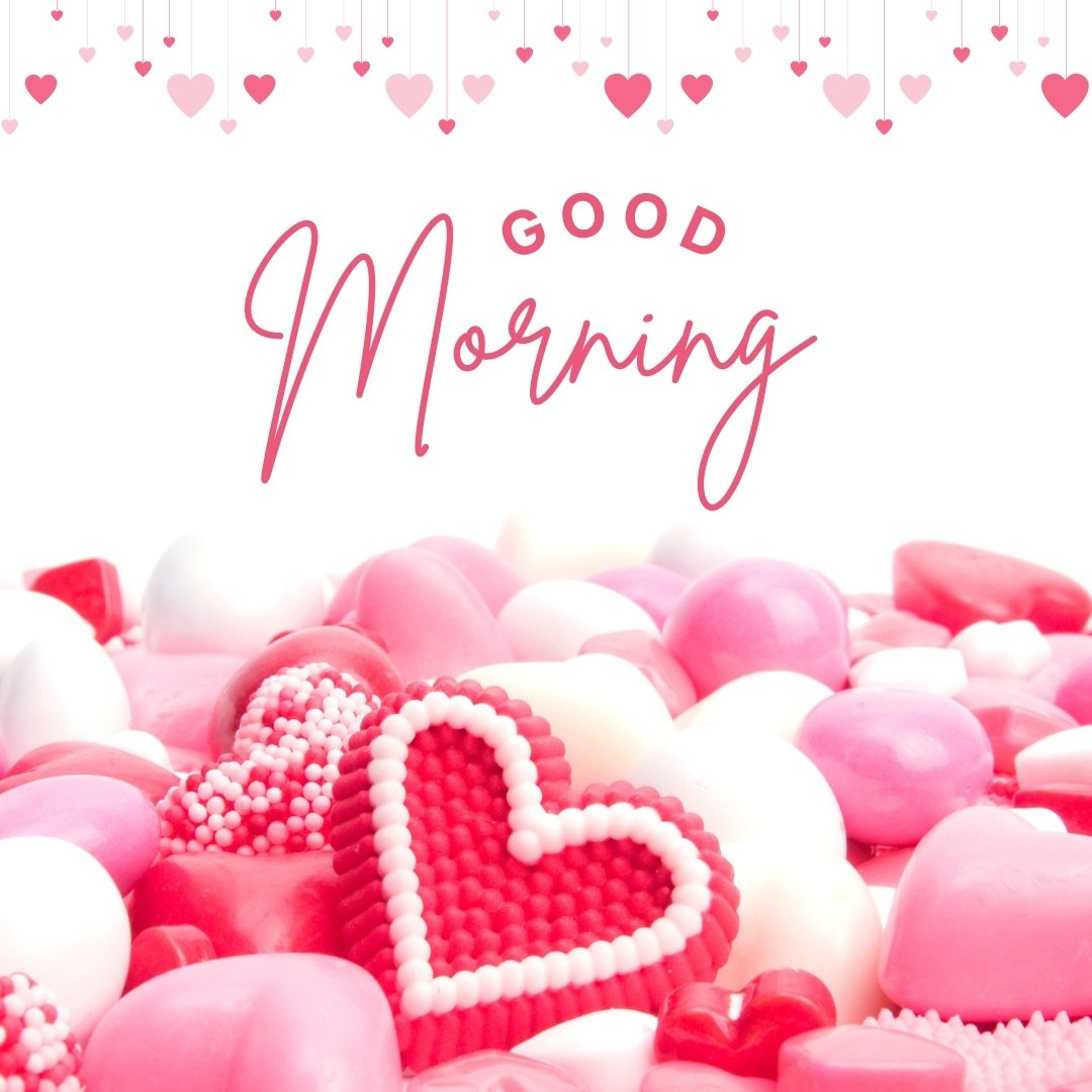 Good morning heart image filled with an assortment of pink and white candies, featuring a standout red heart-shaped candy in the center, under the cursive greeting 'Good Morning' and surrounded by tiny floating hearts