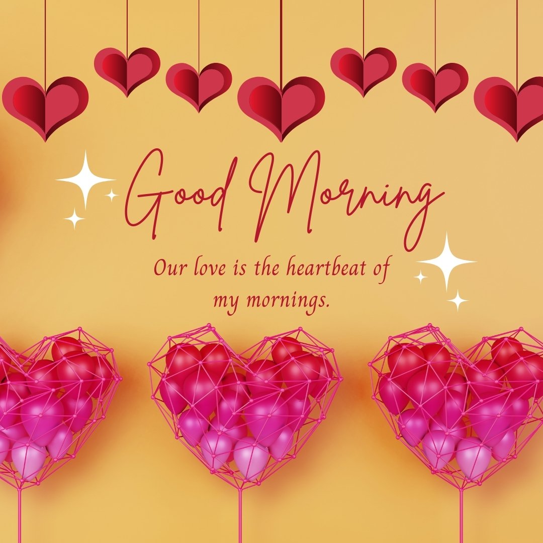 Good morning heart image featuring a row of deep red hearts suspended on strings against a warm orange background, interspersed with striking wireframe pink hearts. The phrase 'Good Morning' prominently displayed above the phrase 'Our love is the heartbeat of my mornings,' evokes a sense of cherished connection and affection.