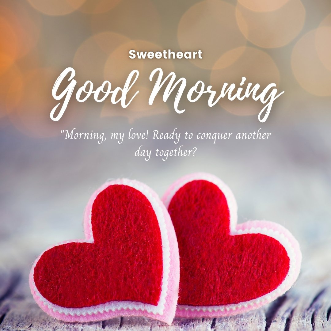 Good morning heart image featuring two plush red hearts on a wooden surface with a soft bokeh background, accompanied by the text 'Sweetheart Good Morning' and the loving quote 'Morning, my love! Ready to conquer another day together?'