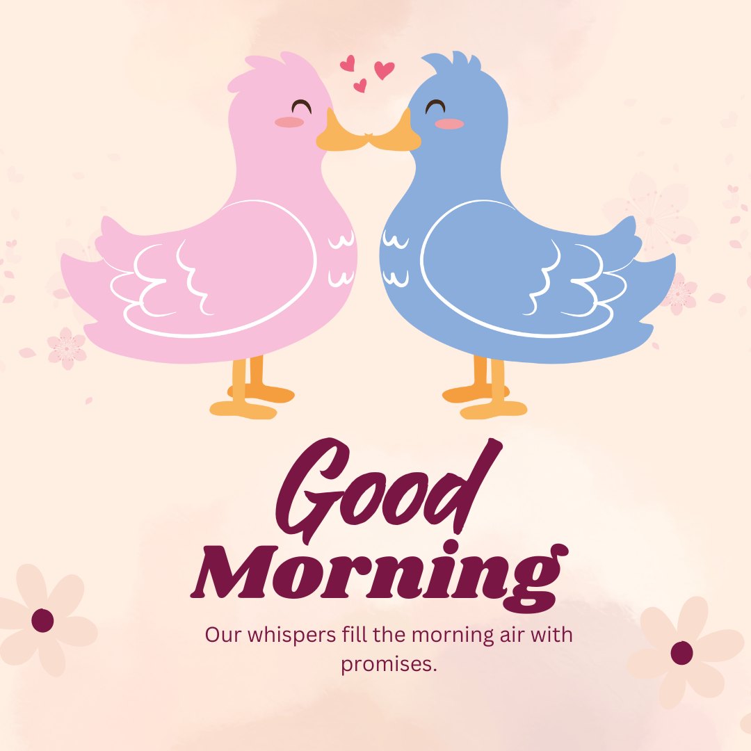 Good Morning Kiss Image with two adorable cartoon birds in pink and blue, tenderly kissing and exchanging hearts on a soft pink background, surrounded by delicate flowers and the text 'Good Morning'.