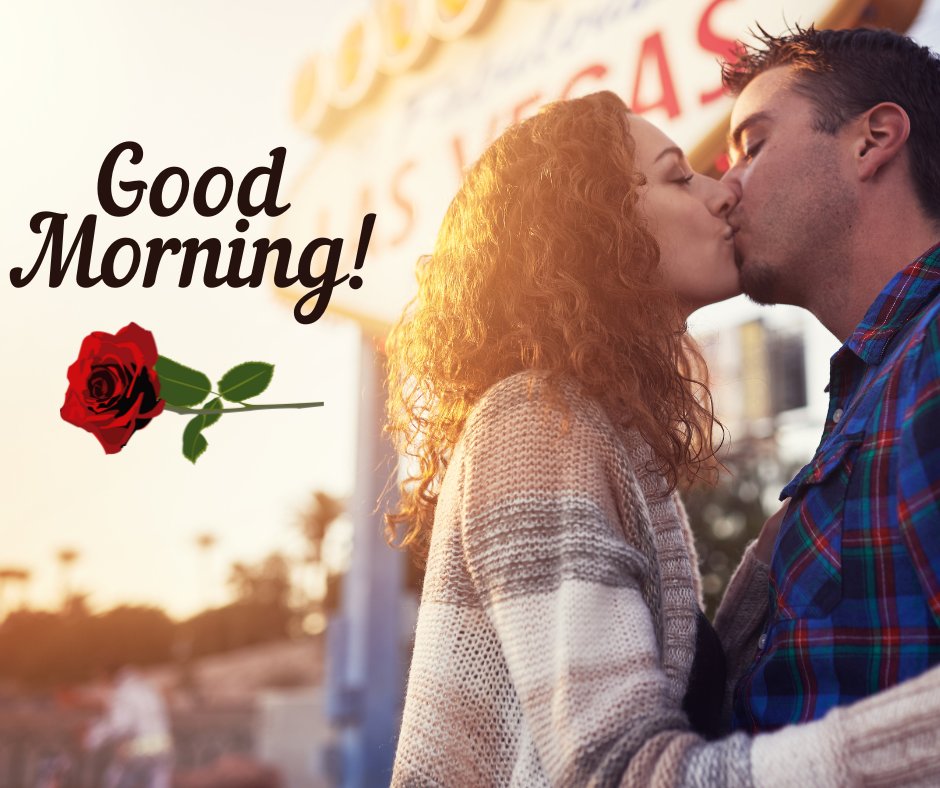 Good Morning Kiss Image of a couple passionately kissing outdoors with a beautiful sunset backdrop near a vibrant cityscape, a single red rose adding a romantic touch.