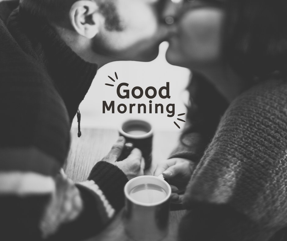 Good Morning Kiss Image of a couple sharing a tender kiss over morning coffee in a cozy, black and white setting.