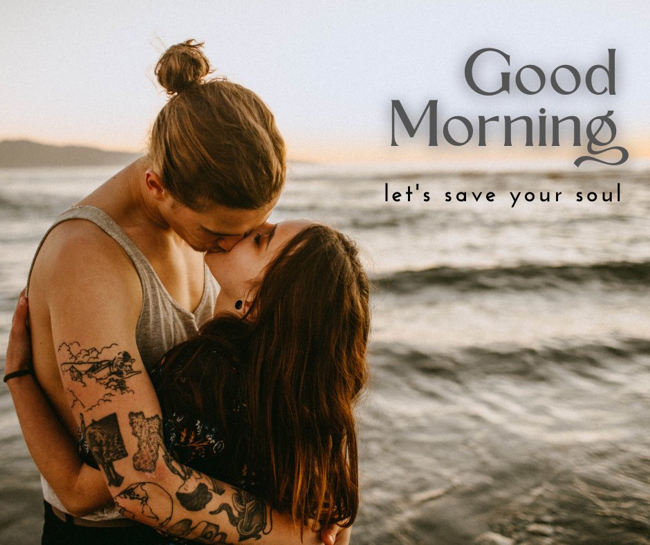 Emotive Good Morning Kiss Image capturing a deeply intimate moment between a couple at the beach during sunrise. The man, with a bun and tattooed arms, gently kisses his partner's forehead as she closes her eyes in a serene embrace. The backdrop features the ocean and fading sunlight with the inspiring caption 'Good Morning - let's save your soul.'