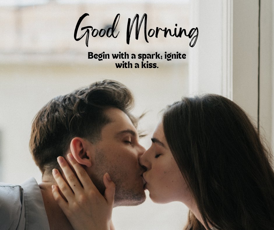 Intimate Good Morning Kiss Image capturing a moment between a couple kissing deeply by a window. The man, with tousled hair, passionately kisses his partner, who gently places her hand on his cheek. The scene is set against a blurred indoor background with the caption 'Good Morning - Begin with a spark; ignite with a kiss.'