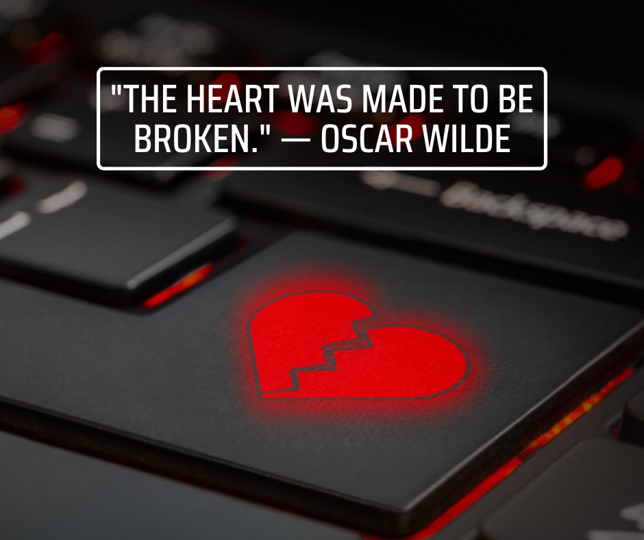 Sad emotional love quote by Oscar Wilde, 'The heart was made to be broken,' illuminated on a laptop keyboard with a glowing red broken heart symbol.